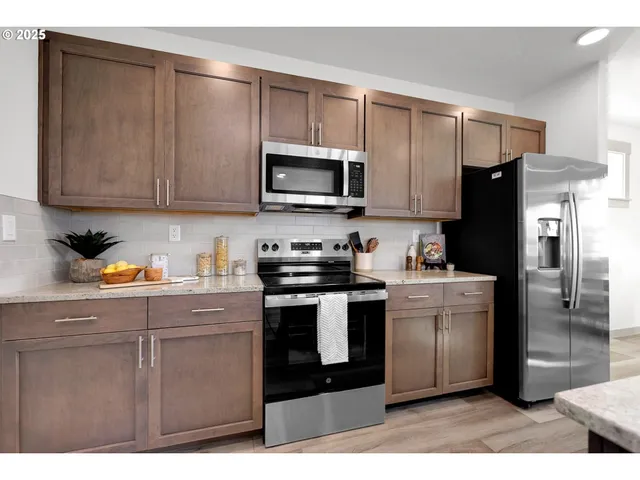a kitchen with a refrigerator stove and microwave