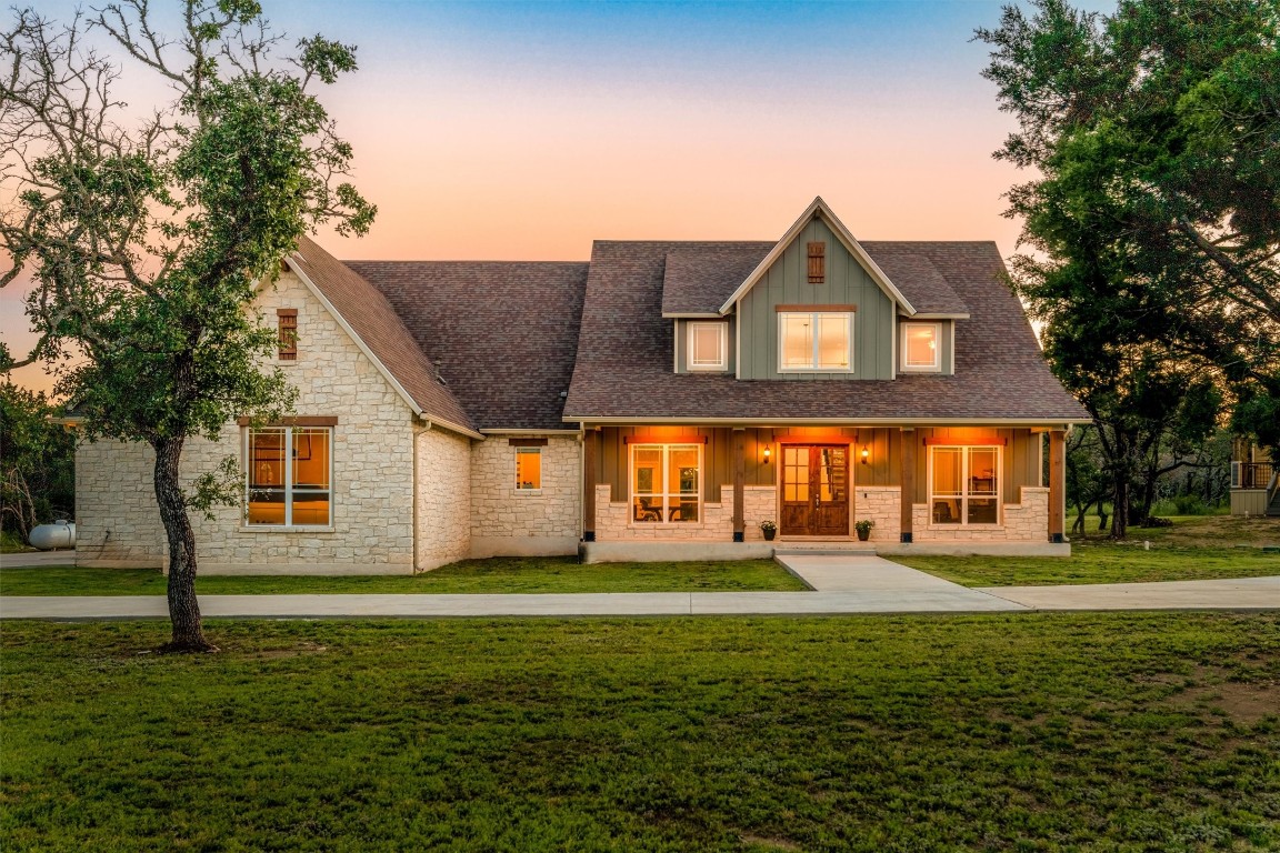 a front view of house with yard and green space