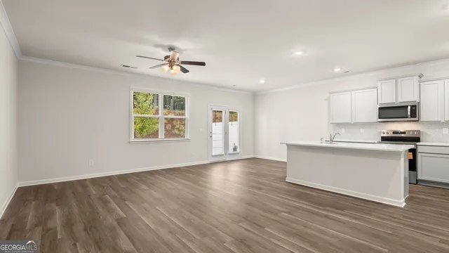 a view of a house with backyard and a tree