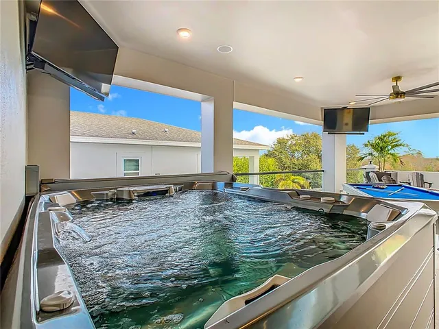 a view of a dining room with furniture and a chandelier