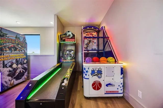 a large kitchen with a large counter top a sink stainless steel appliances and cabinets