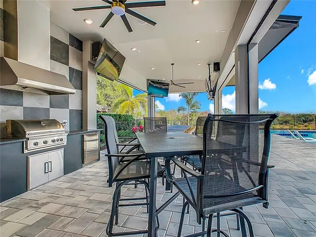 a spacious bedroom with a bed a couch and large window