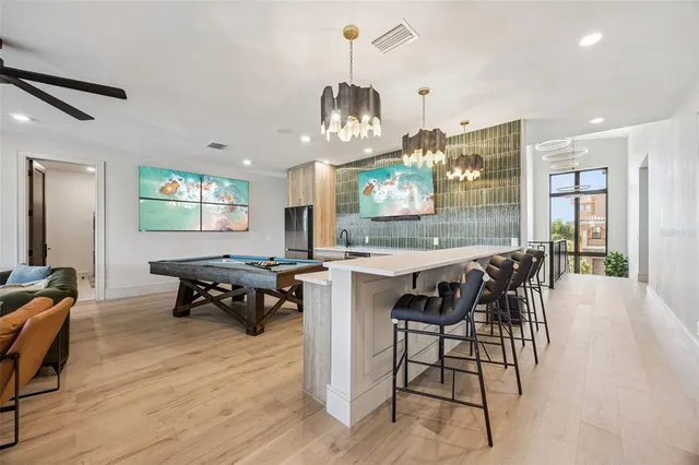 a bedroom with a bed a couch and a flat screen tv