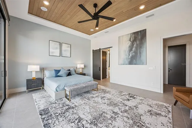 a bedroom with a large bed and a couch