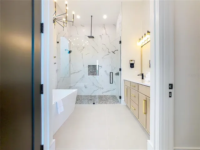 a spacious bathroom with double vanity and a mirror