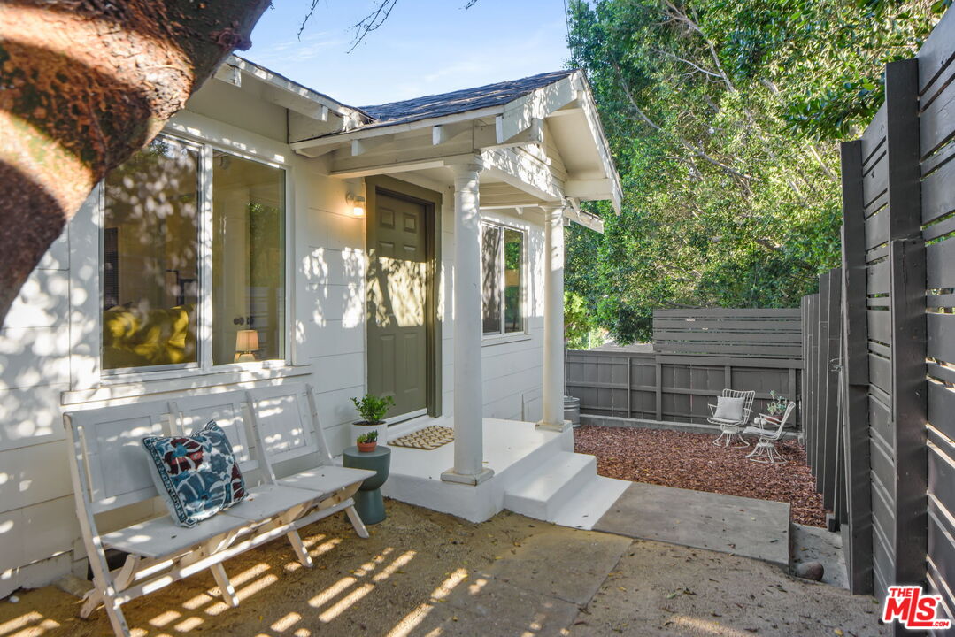 a view of a porch with chairs and couches