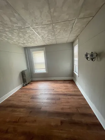 a view of an empty room and wooden floor