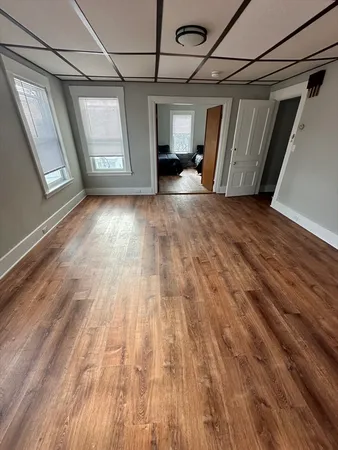 a bedroom with a bed window and couch