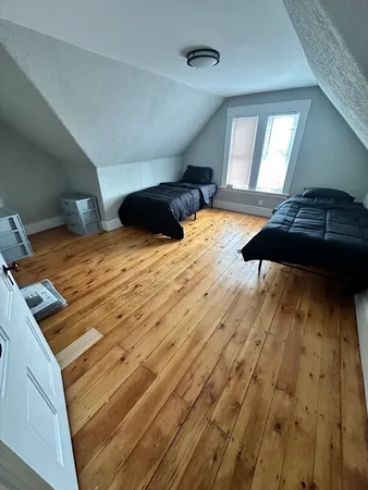 a bedroom with double bed and a window