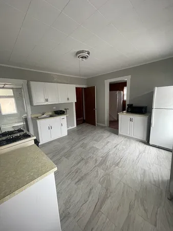 a kitchen with a stove and a refrigerator