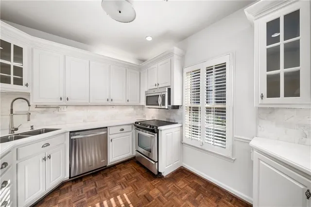 a kitchen with granite countertop a stove and a sink
