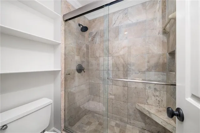 a bathroom with a shower and toilet