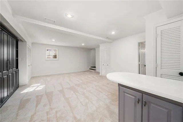 a view of a kitchen with a sink and refrigerator