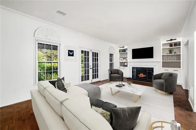 a living room with furniture a fireplace and a flat screen tv