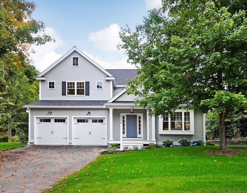 174 Wright Road Concord, MA 01742 - Photo 1 of 35 a front view of a house with a garden and trees
