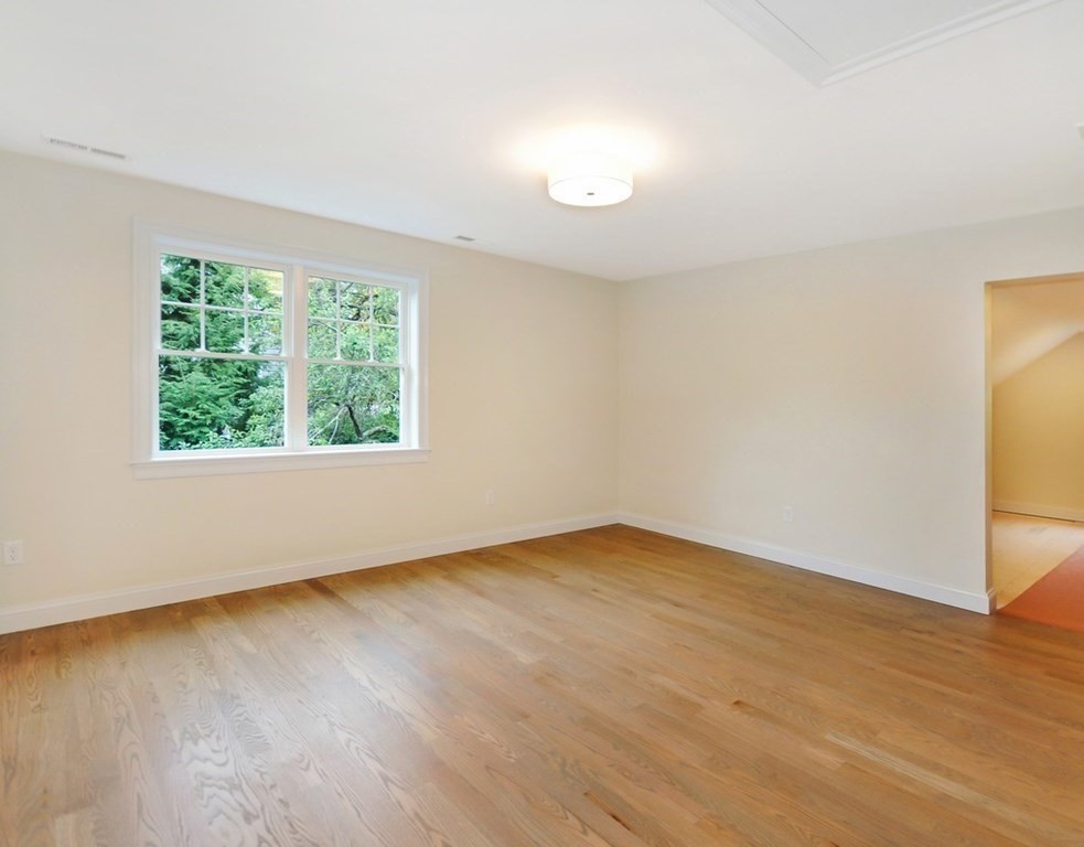 174 Wright Road Concord, MA 01742 - Photo 22 of 35 an empty room with wooden floor and windows