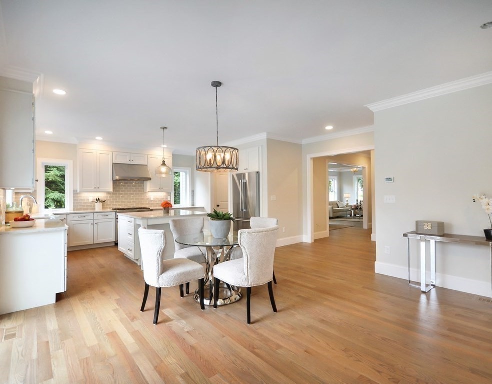 174 Wright Road Concord, MA 01742 - Photo 29 of 35 a view of a dining room and livingroom with furniture wooden floor a rug a chandelier