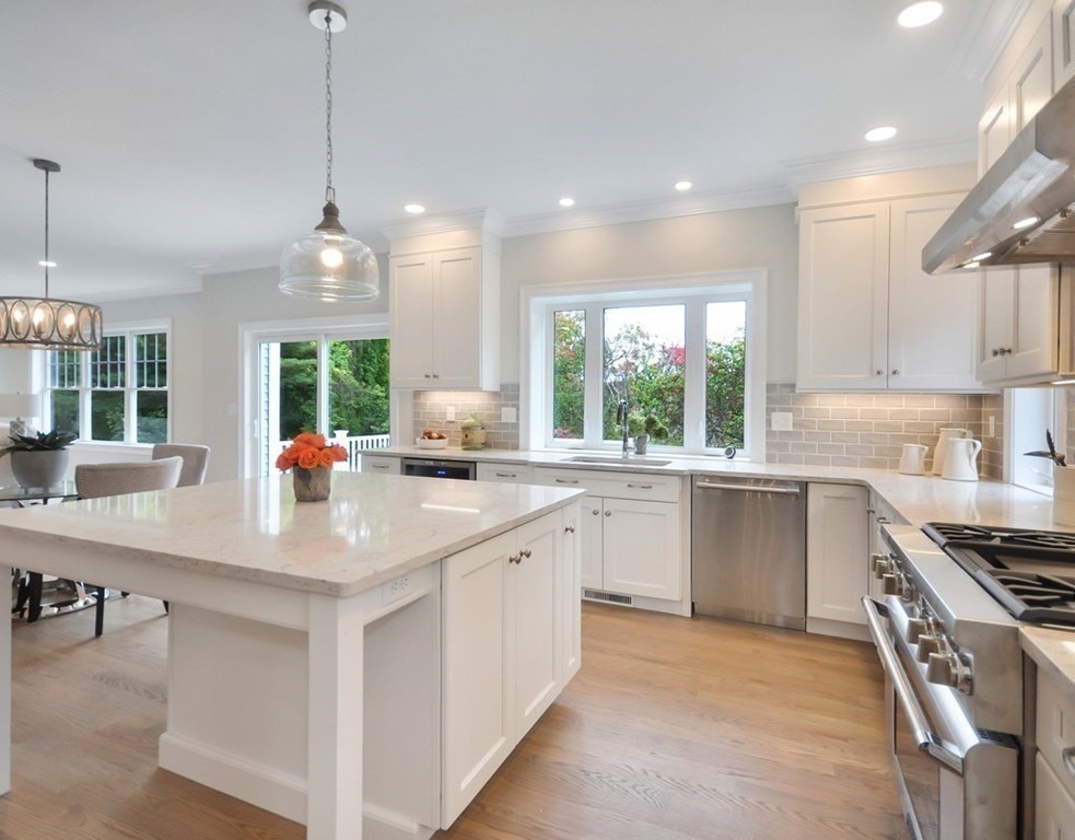 174 Wright Road Concord, MA 01742 - Photo 3 of 35 a kitchen with stainless steel appliances granite countertop a sink a stove a kitchen island and windows