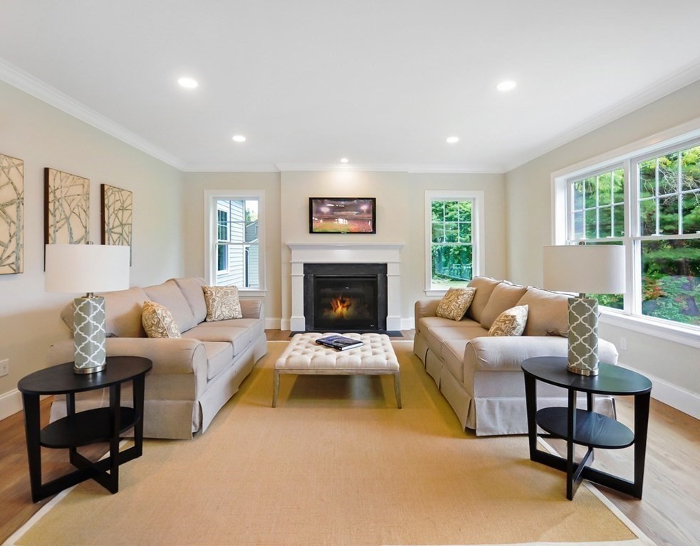 174 Wright Road Concord, MA 01742 - Photo 7 of 35 a living room with furniture and a fireplace