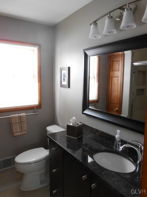 250 Ridgewood Road Easton, PA 18045 - Photo 17 of 21 a bathroom with a granite countertop sink toilet a mirror and a window