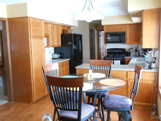 250 Ridgewood Road Easton, PA 18045 - Photo 7 of 21 a dining room with furniture a kitchen view and a refrigerator