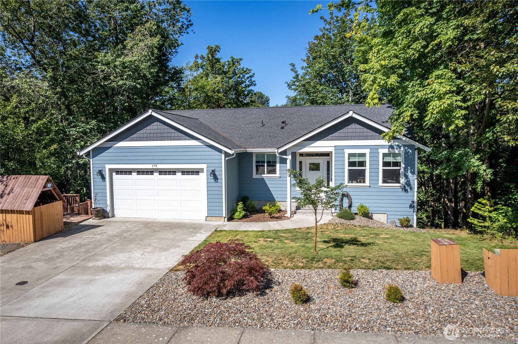 a front view of a house with a yard and garage