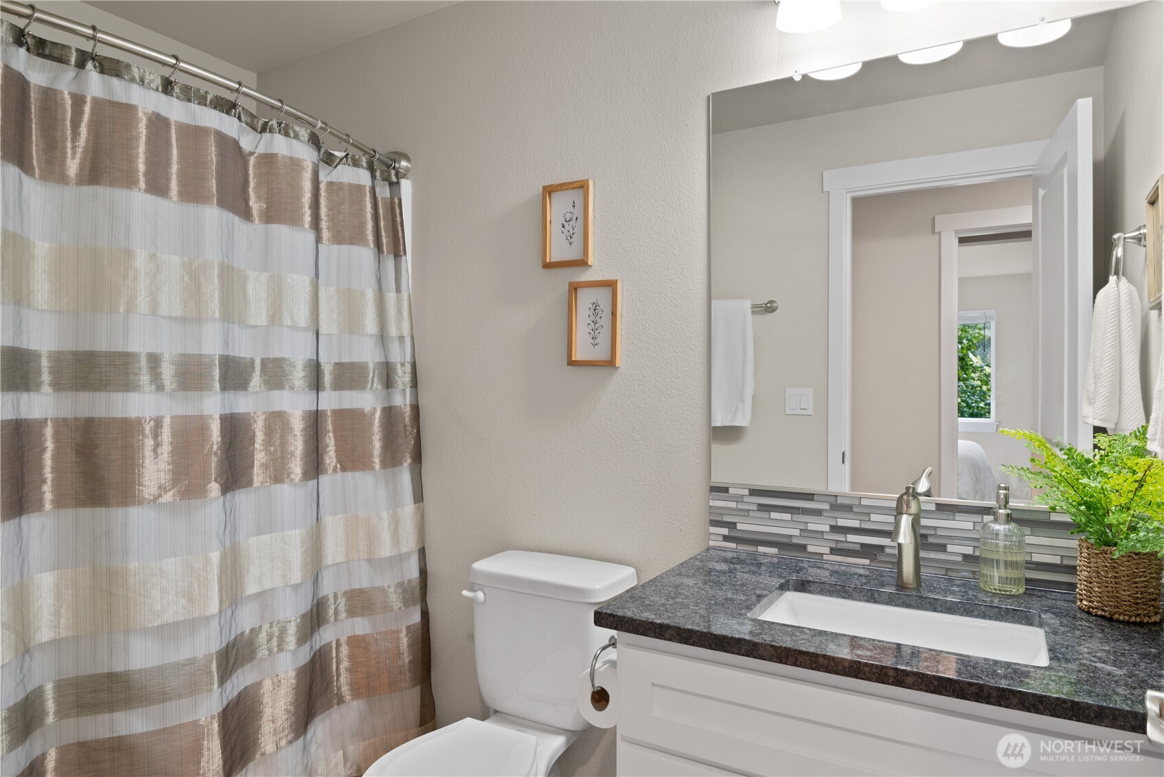 175 Shoreview Drive Kelso, WA 98626 - Photo 20 of 35 a bathroom with a granite countertop sink a toilet a mirror and shower