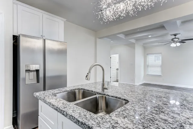 a close view of a sink and livingroom