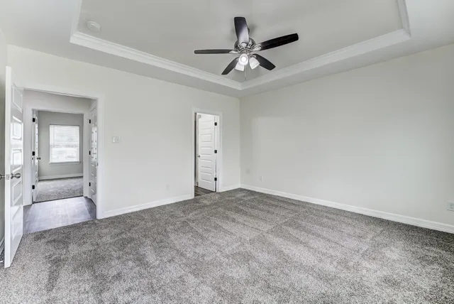 a view of a livingroom with a ceiling fan and window