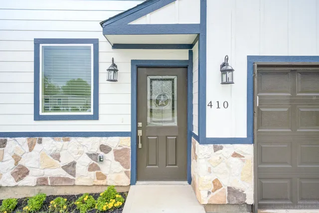 a front view of a house with white walls