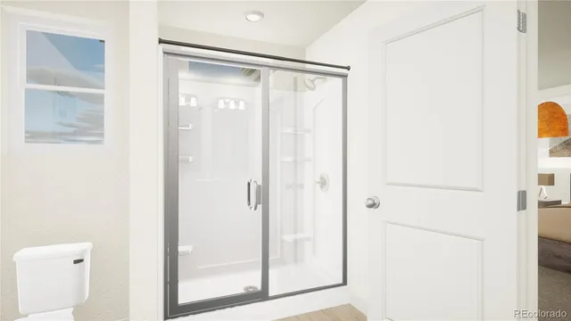 a bathroom with a glass shower door