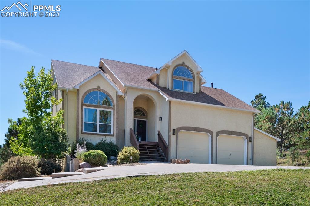 a front view of a house with garden