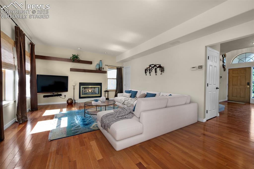 7425 Tobin Road Colorado Springs, CO 80908 - Photo 12 of 49 a living room with furniture fireplace and flat screen tv