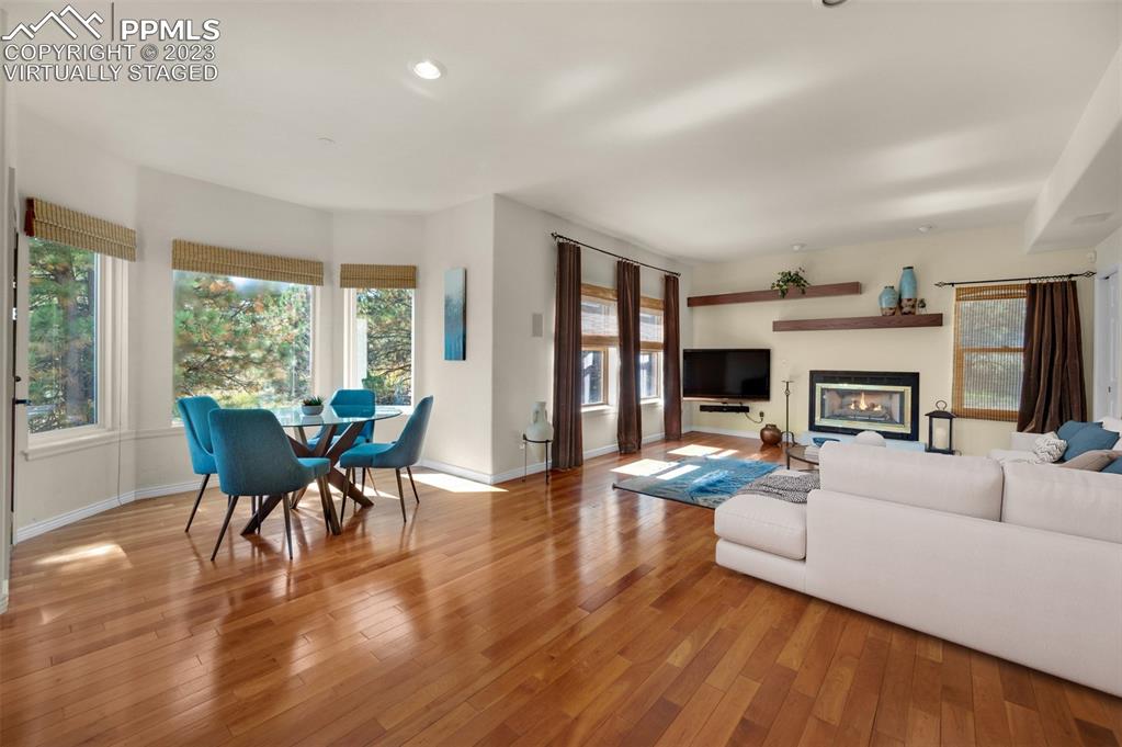 7425 Tobin Road Colorado Springs, CO 80908 - Photo 14 of 49 a living room with fireplace furniture and a wooden floor