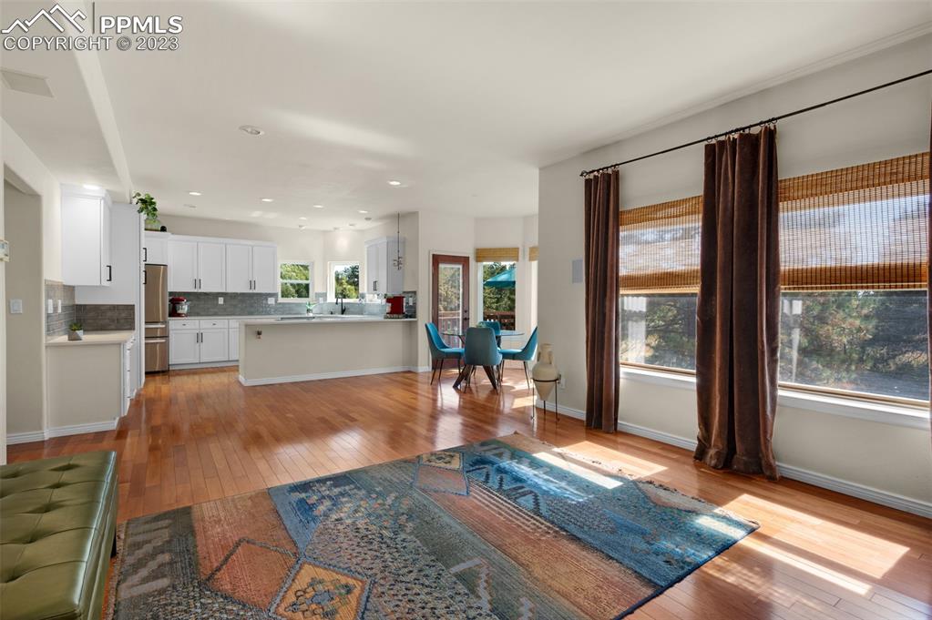 7425 Tobin Road Colorado Springs, CO 80908 - Photo 17 of 49 a living room with stainless steel appliances granite countertop furniture wooden floor and a large window
