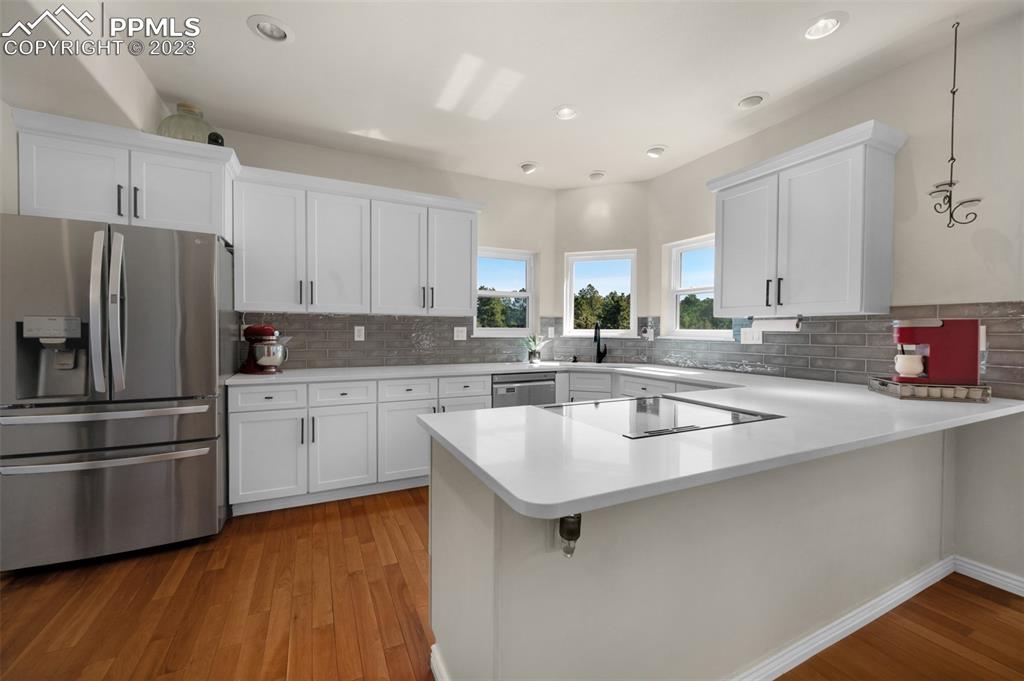7425 Tobin Road Colorado Springs, CO 80908 - Photo 19 of 49 a kitchen with stainless steel appliances granite countertop a sink stove and refrigerator