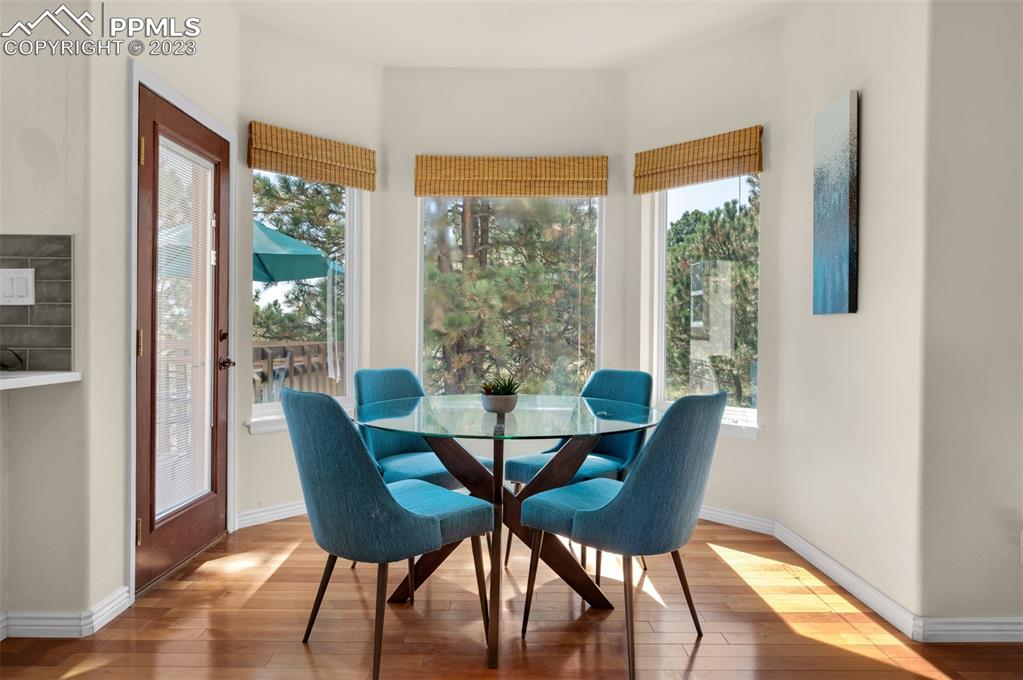 7425 Tobin Road Colorado Springs, CO 80908 - Photo 21 of 49 a view of a dining room with furniture and wooden floor
