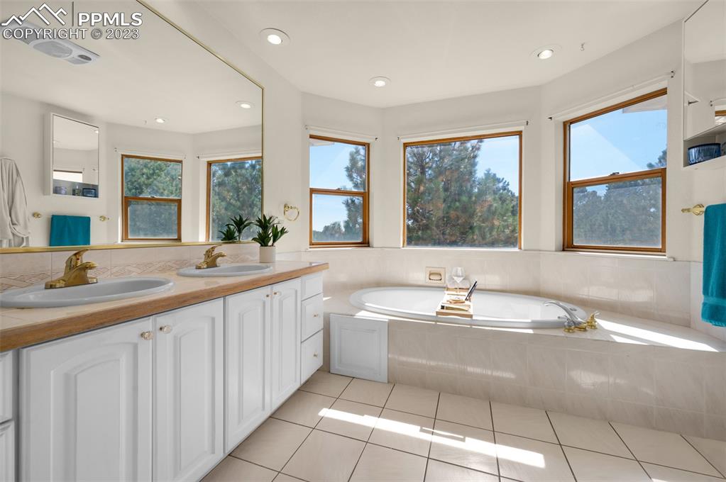 7425 Tobin Road Colorado Springs, CO 80908 - Photo 32 of 49 a large bathroom with a large tub sink and large mirror