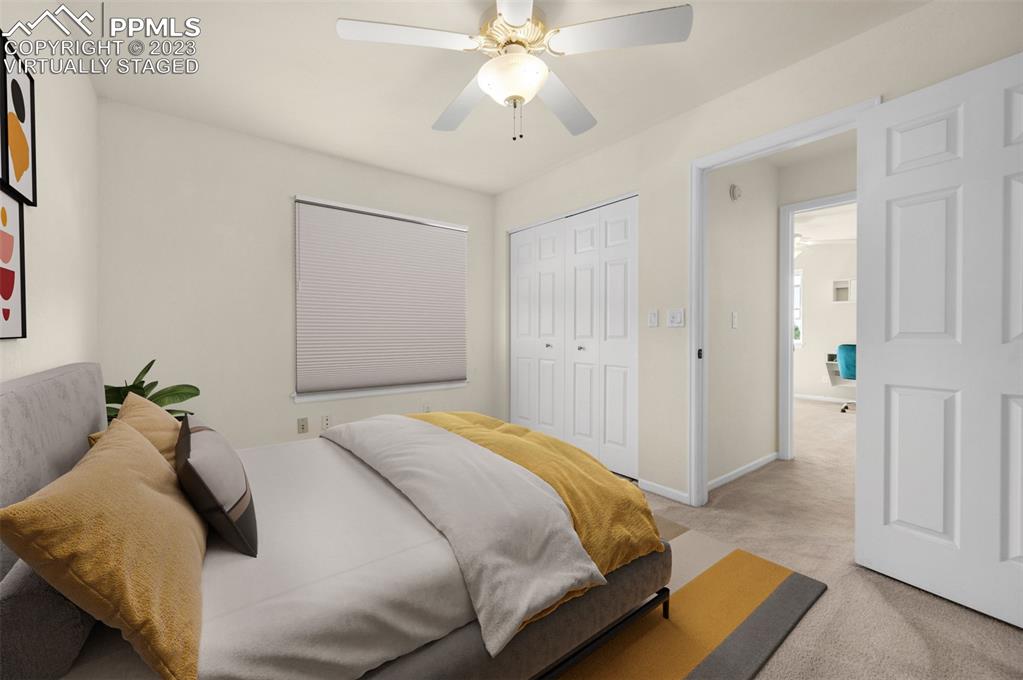 7425 Tobin Road Colorado Springs, CO 80908 - Photo 36 of 49 a bedroom with a bed and a chandelier