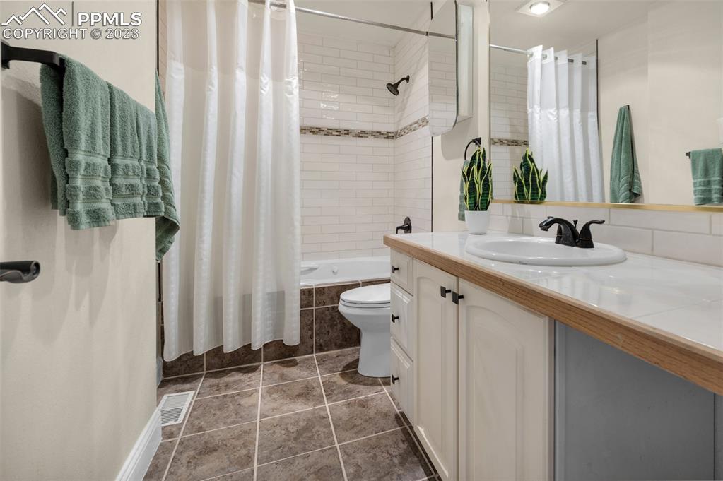 7425 Tobin Road Colorado Springs, CO 80908 - Photo 38 of 49 a bathroom with a double vanity sink toilet and shower