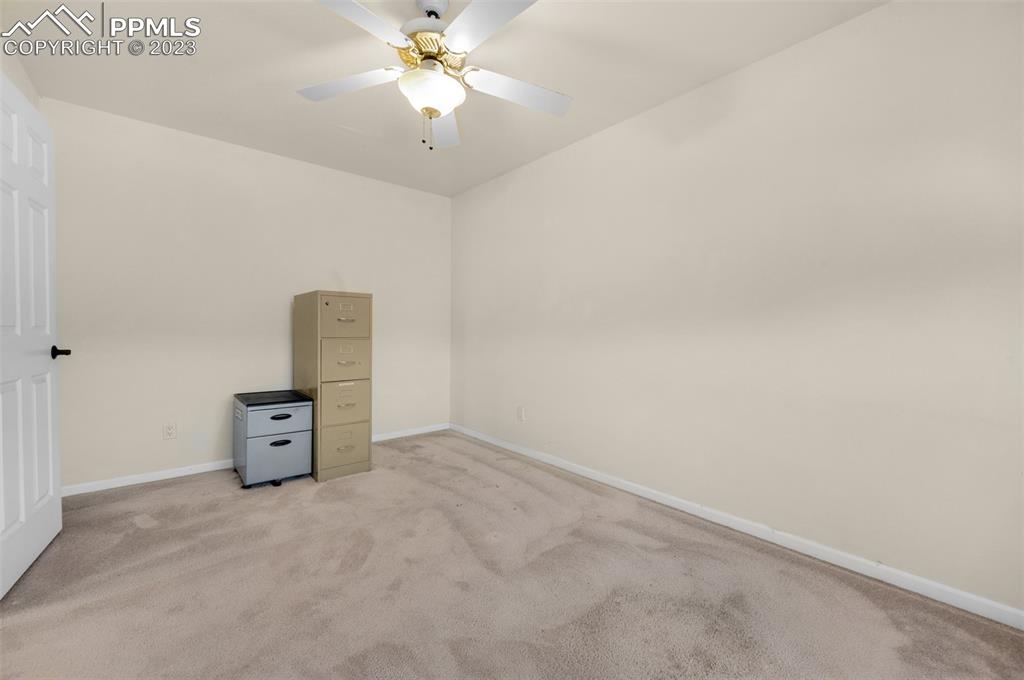 7425 Tobin Road Colorado Springs, CO 80908 - Photo 40 of 49 an empty room with a cabinet and chandelier
