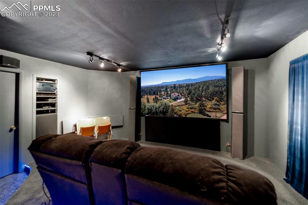 7425 Tobin Road Colorado Springs, CO 80908 - Photo 41 of 49 a bedroom with a bed and glass wall