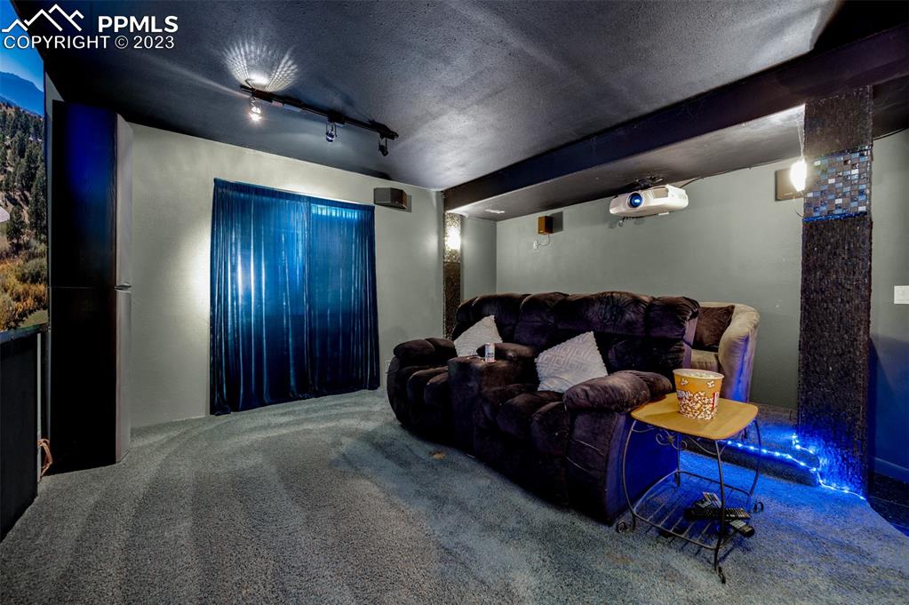 7425 Tobin Road Colorado Springs, CO 80908 - Photo 42 of 49 a living room with furniture a dining table and a fireplace