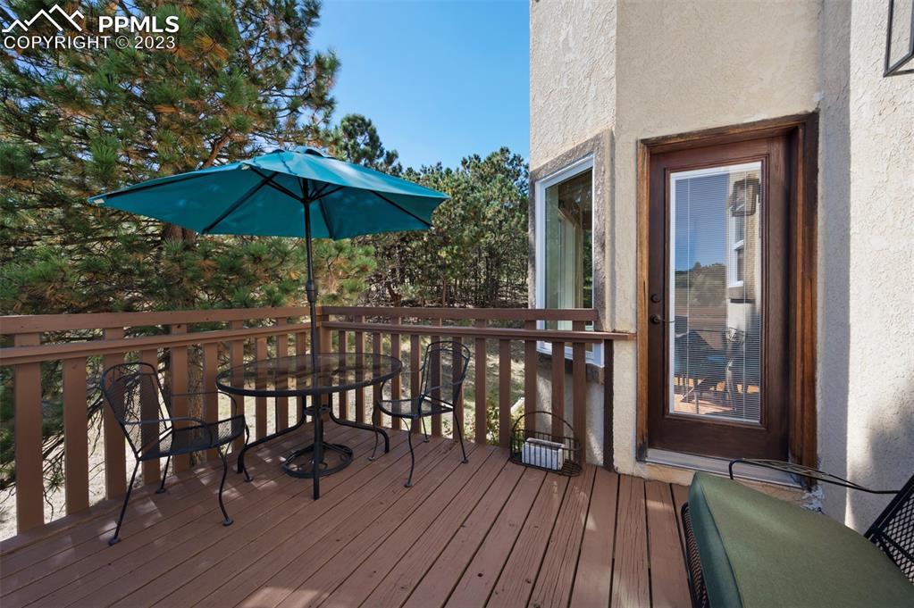 7425 Tobin Road Colorado Springs, CO 80908 - Photo 43 of 49 a view of balcony with furniture and wooden floor