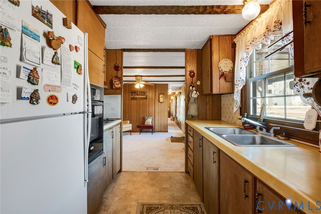 475 Dove Road Boydton, VA 23917 - Photo 11 of 45 a kitchen with a refrigerator and a sink