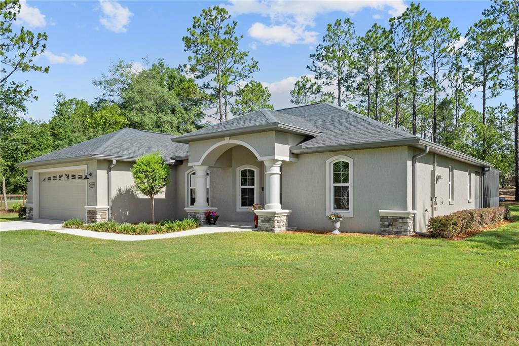 12929 Southwest 89th Street Dunnellon, FL 34432 - Photo 33 of 76 a front view of house with yard and green space