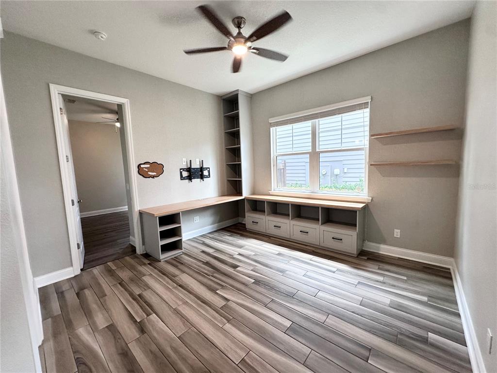 9319 Richet Place Orlando, FL 32827 - Photo 12 of 50 a spacious bedroom with a bed and a window