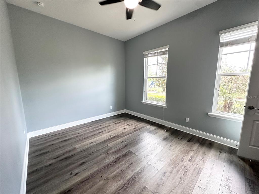 9319 Richet Place Orlando, FL 32827 - Photo 16 of 50 wooden floor in an empty room with a window