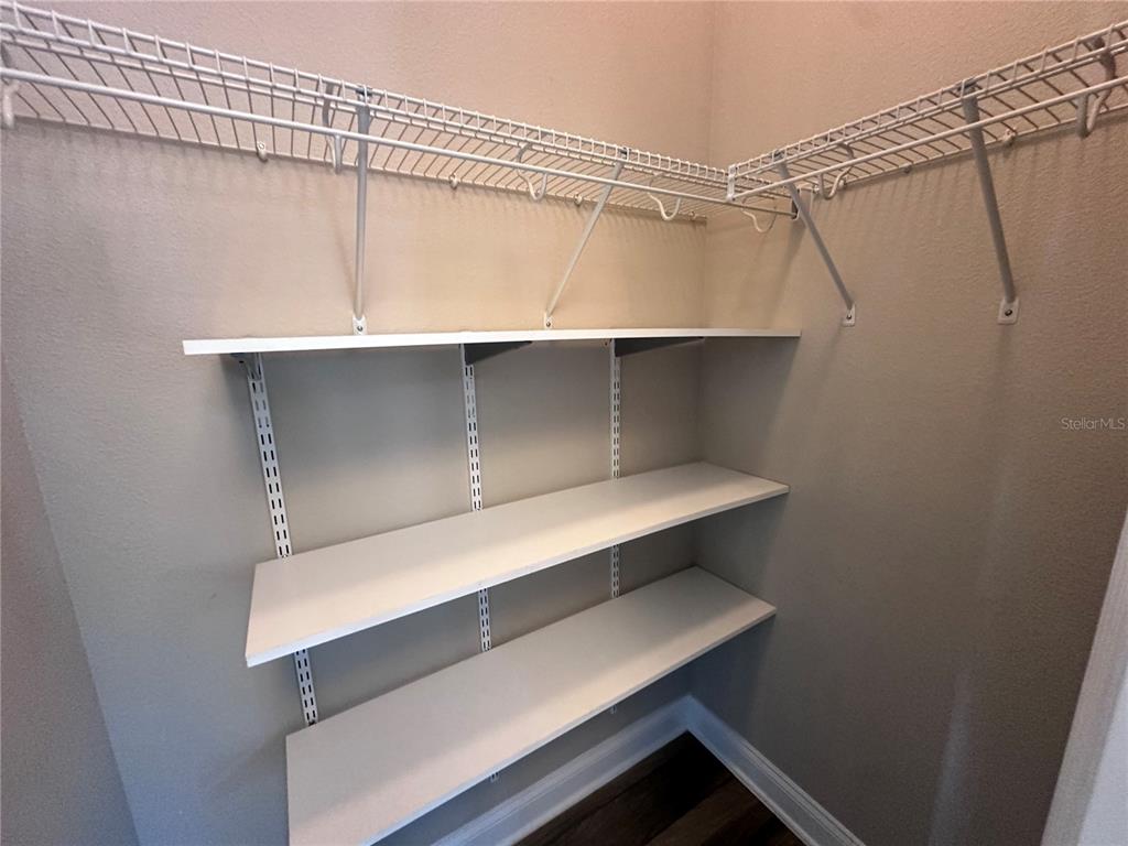 9319 Richet Place Orlando, FL 32827 - Photo 18 of 50 a view of walk in closet with clothes