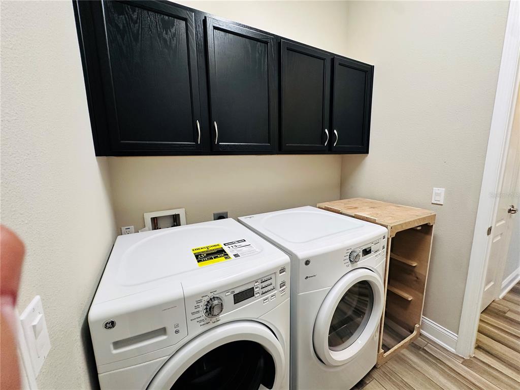 9319 Richet Place Orlando, FL 32827 - Photo 20 of 50 a utility room with dryer and washer